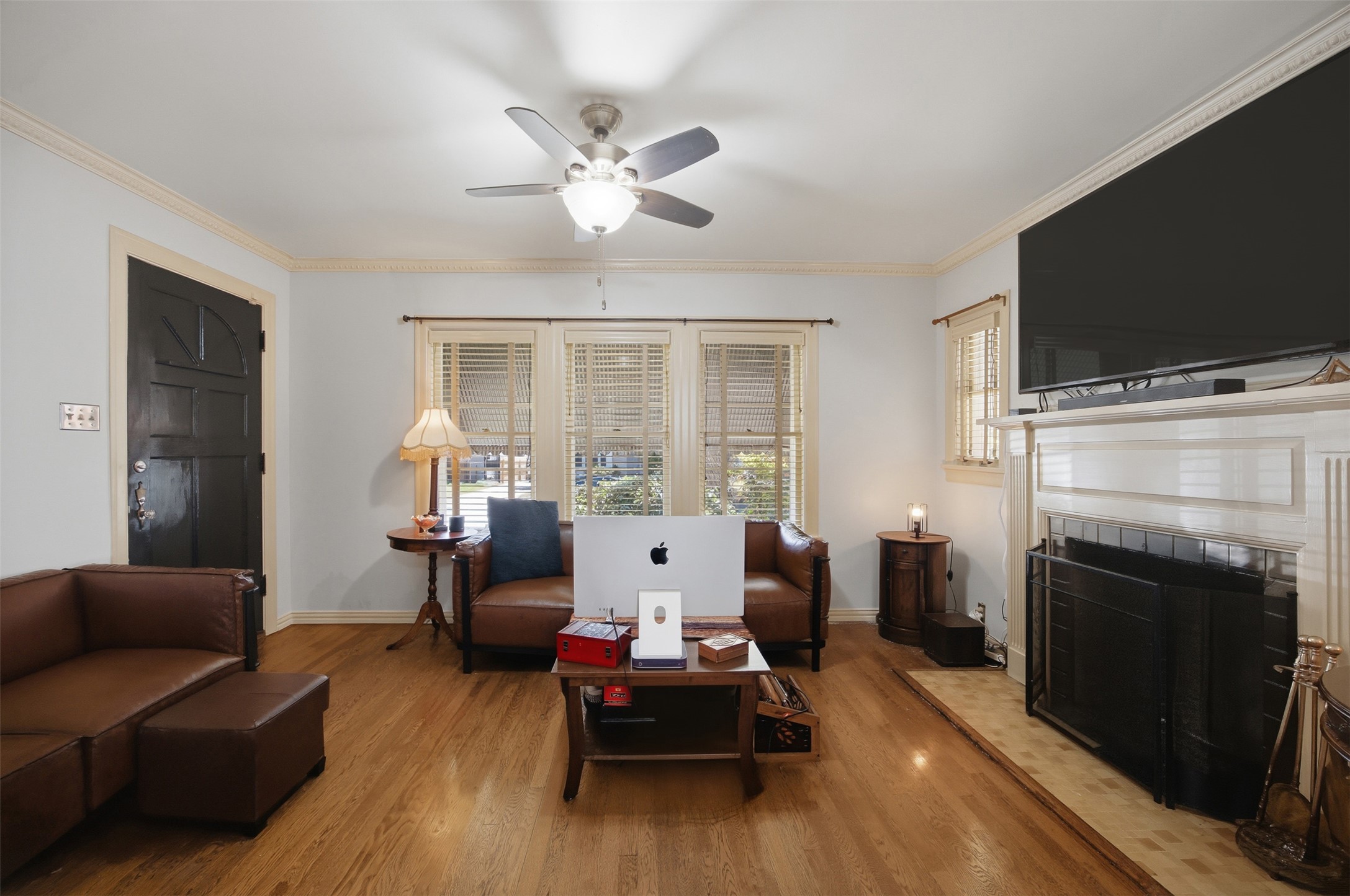 1030 East 44th Street Austin, TX 78751 - Photo 4 of 29 a living room with furniture a flat screen tv and a fireplace