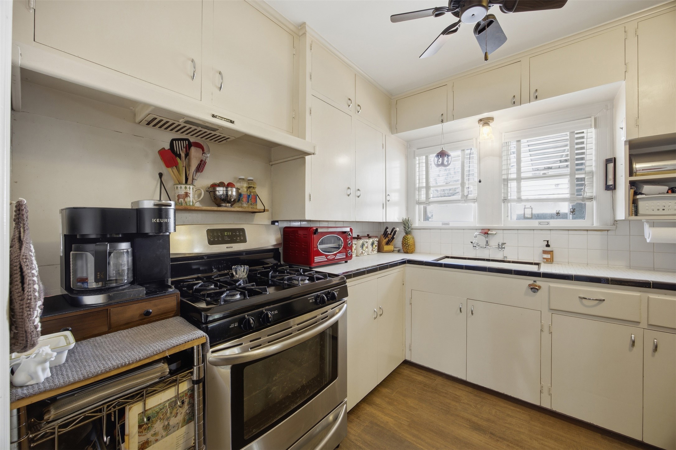 1030 East 44th Street Austin, TX 78751 - Photo 9 of 29 a kitchen with stainless steel appliances a sink stove and cabinets