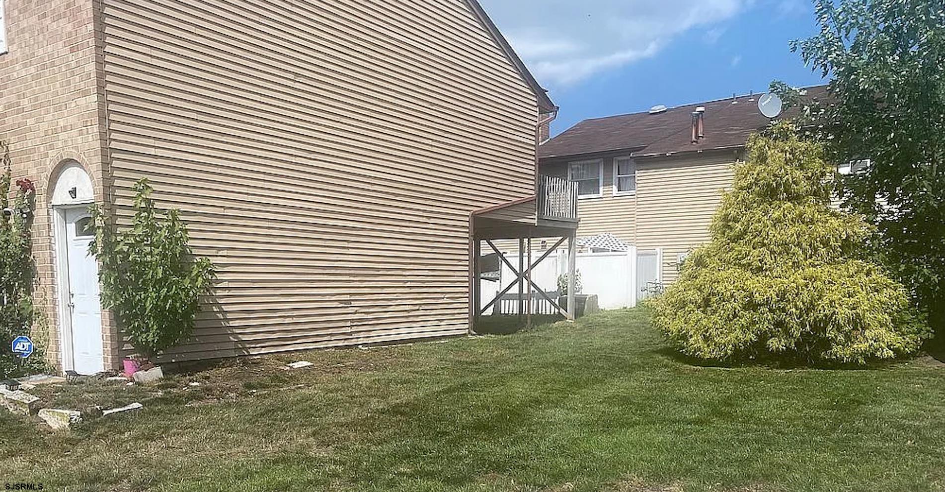 171 Via Cascata Drive, Unit B Clementon, NJ 08021 - Photo 7 of 7 a backyard of a house with lots of green space