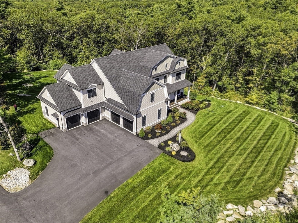 an aerial view of a house with a yard