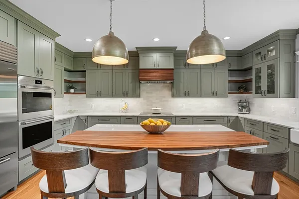 a view of a dining room with furniture a chandelier and wooden floor