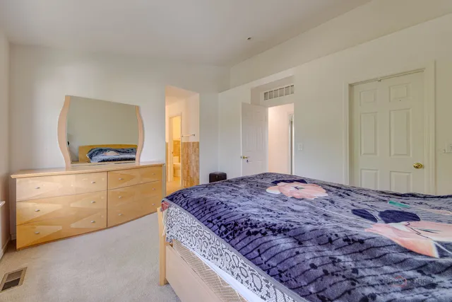 a bedroom with a bed and a dresser