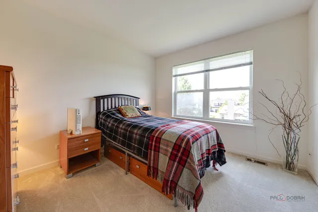 a bed sitting in a bedroom next to a window