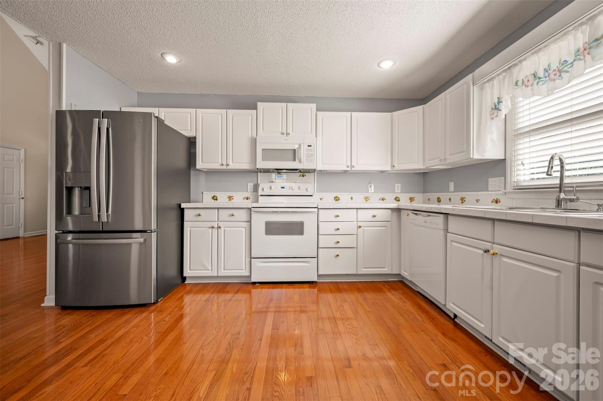 506 Pleasant Street Spindale, NC 28160 - Photo 9 of 42 a kitchen with stainless steel appliances a refrigerator sink and cabinets