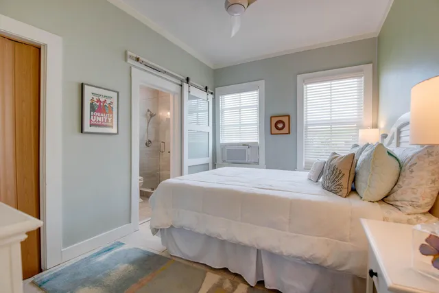 a bedroom with a large bed and a window