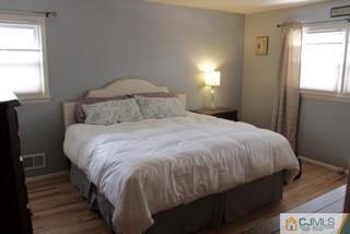 65 Wilk Road Edison, NJ 08837 - Photo 12 of 17 a large bed sitting in a bedroom next to a window