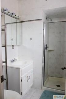 65 Wilk Road Edison, NJ 08837 - Photo 16 of 17 a bathroom with a shower sink and mirror
