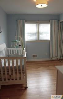 65 Wilk Road Edison, NJ 08837 - Photo 17 of 17 a view of wooden floor and windows in a room