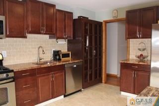 65 Wilk Road Edison, NJ 08837 - Photo 4 of 17 a kitchen with stainless steel appliances granite countertop a refrigerator and a sink