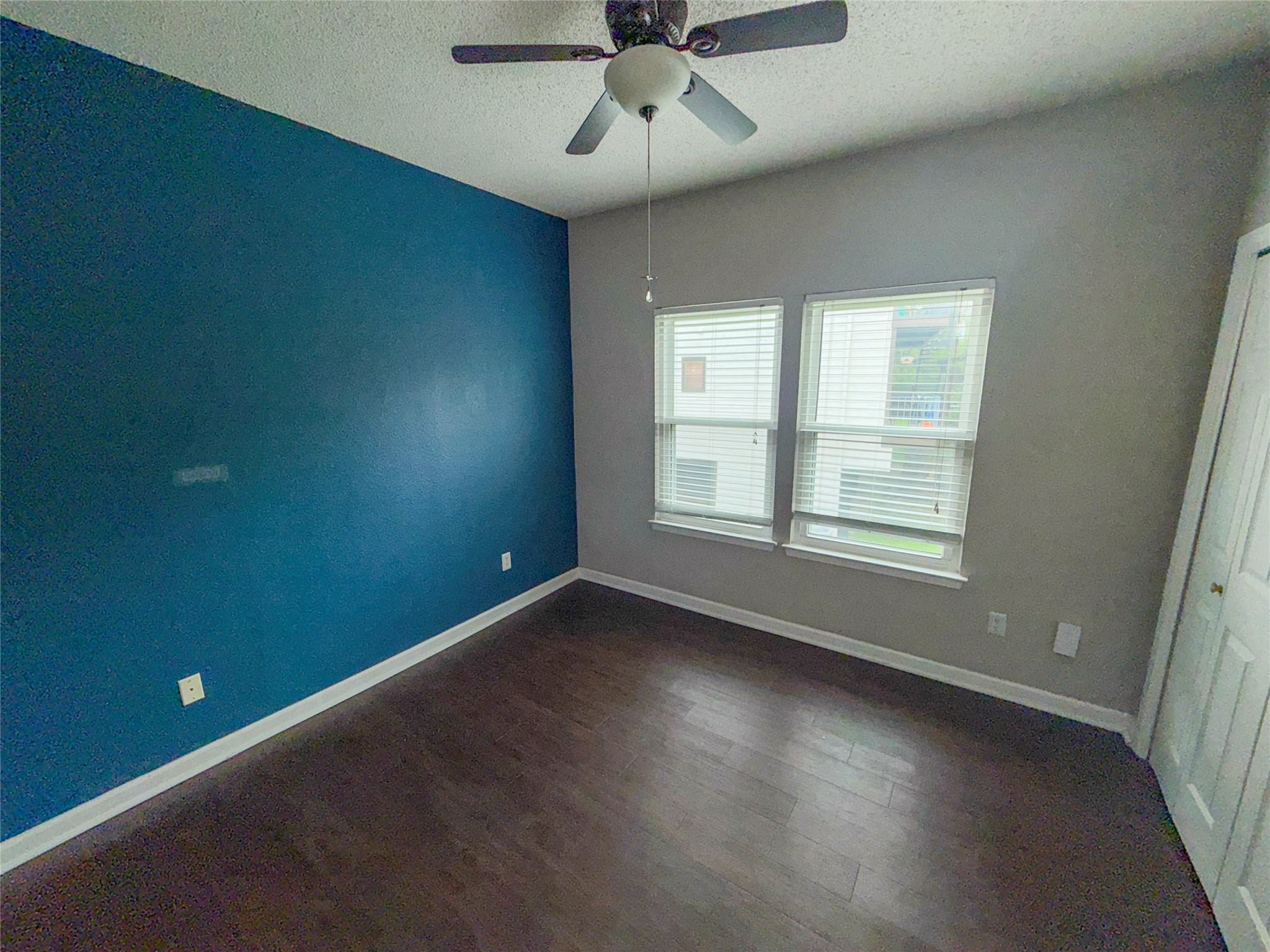 5313 Indio Drive, Unit D Austin, TX 78745 - Photo 11 of 17 an empty room with a window and ceiling fan