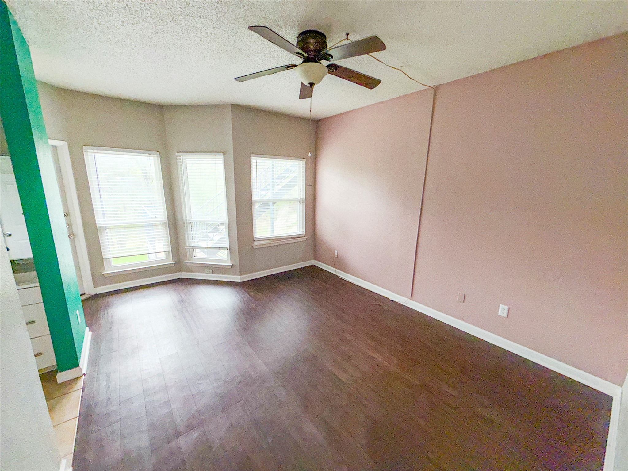 5313 Indio Drive, Unit D Austin, TX 78745 - Photo 13 of 17 an empty room with windows and fan