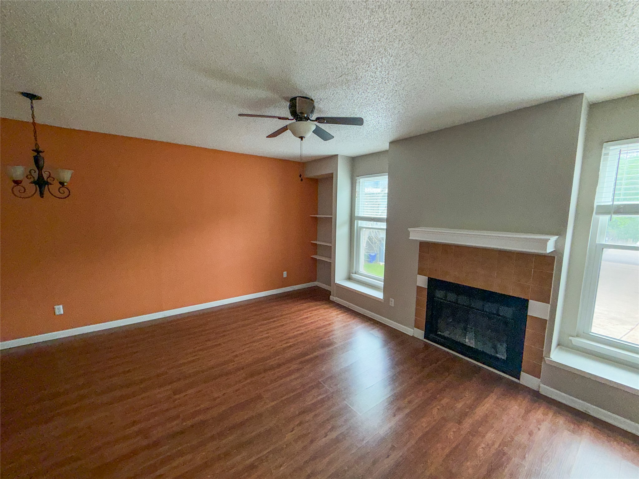 5313 Indio Drive, Unit D Austin, TX 78745 - Photo 5 of 17 an empty room with wooden floor fireplace and windows