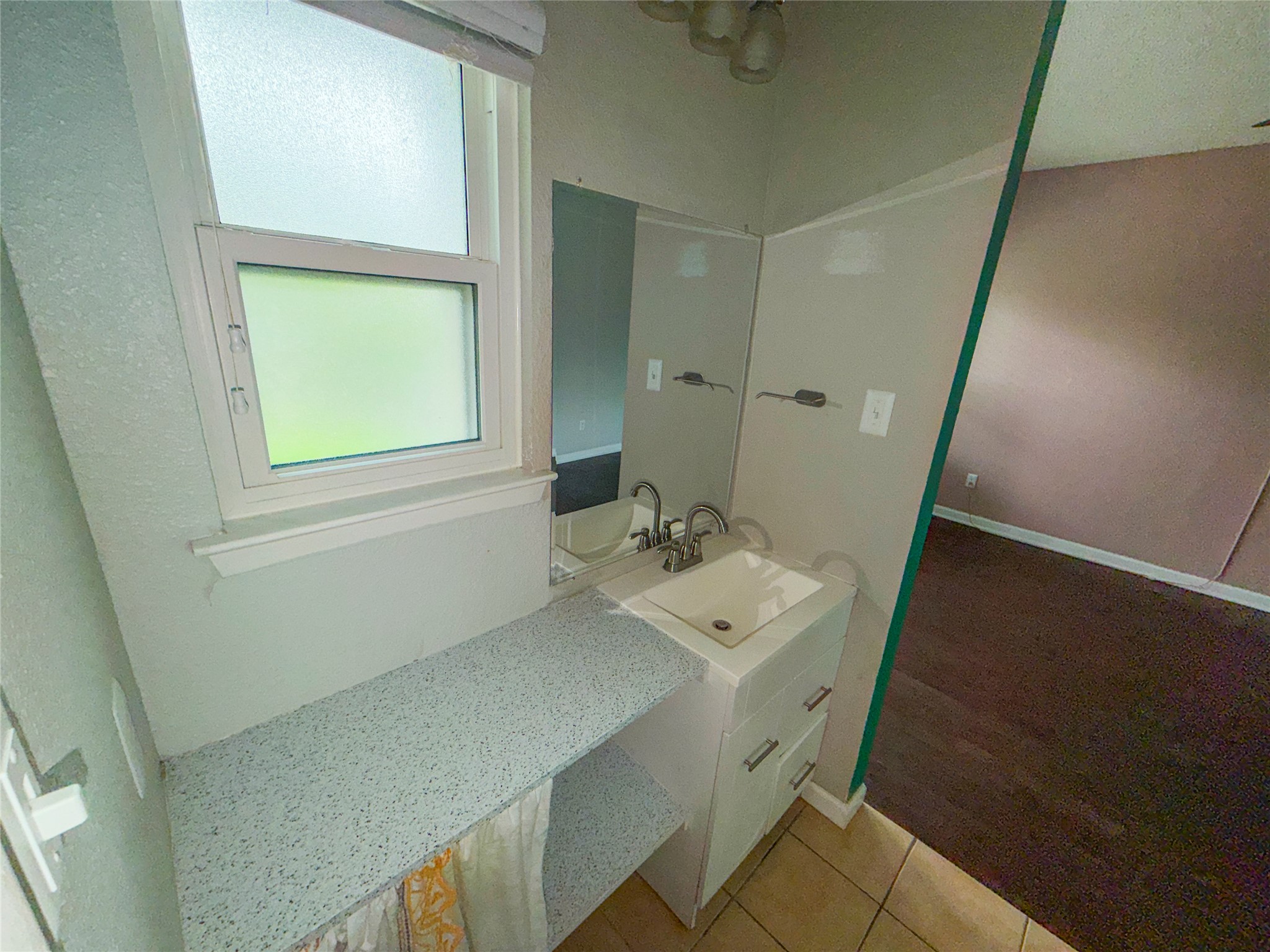 5313 Indio Drive, Unit D Austin, TX 78745 - Photo 9 of 17 a bathroom with a sink a mirror and a window