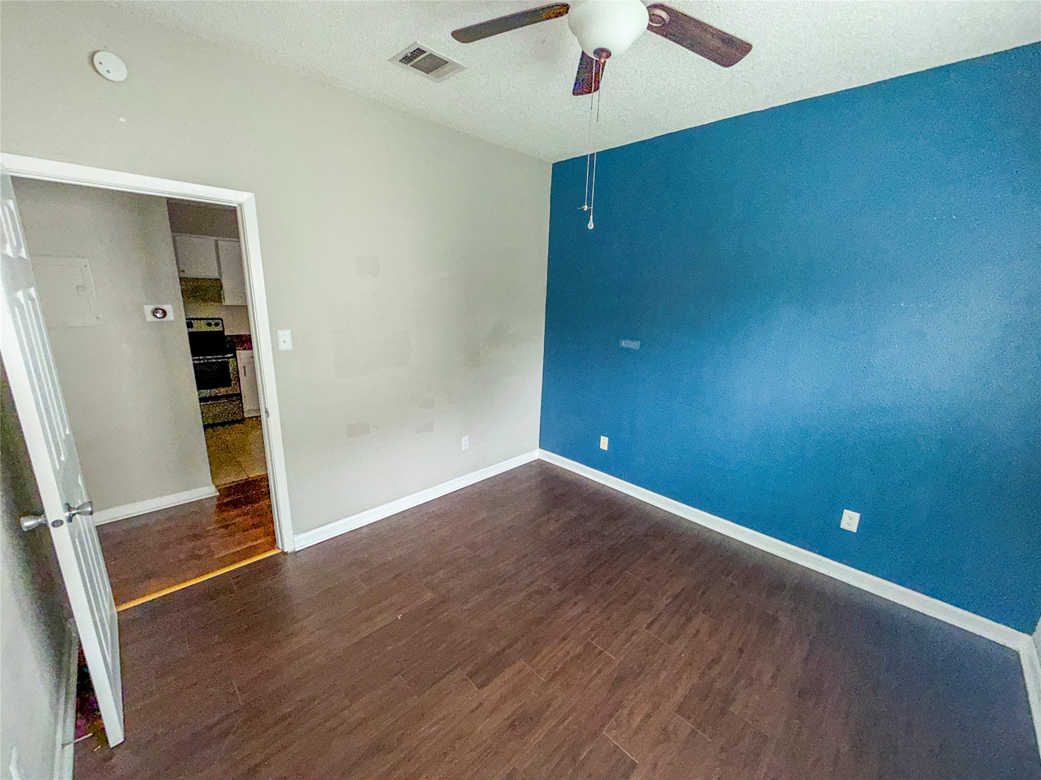 5313 Indio Drive, Unit D Austin, TX 78745 - Photo 10 of 17 an empty room with wooden floor and entryway