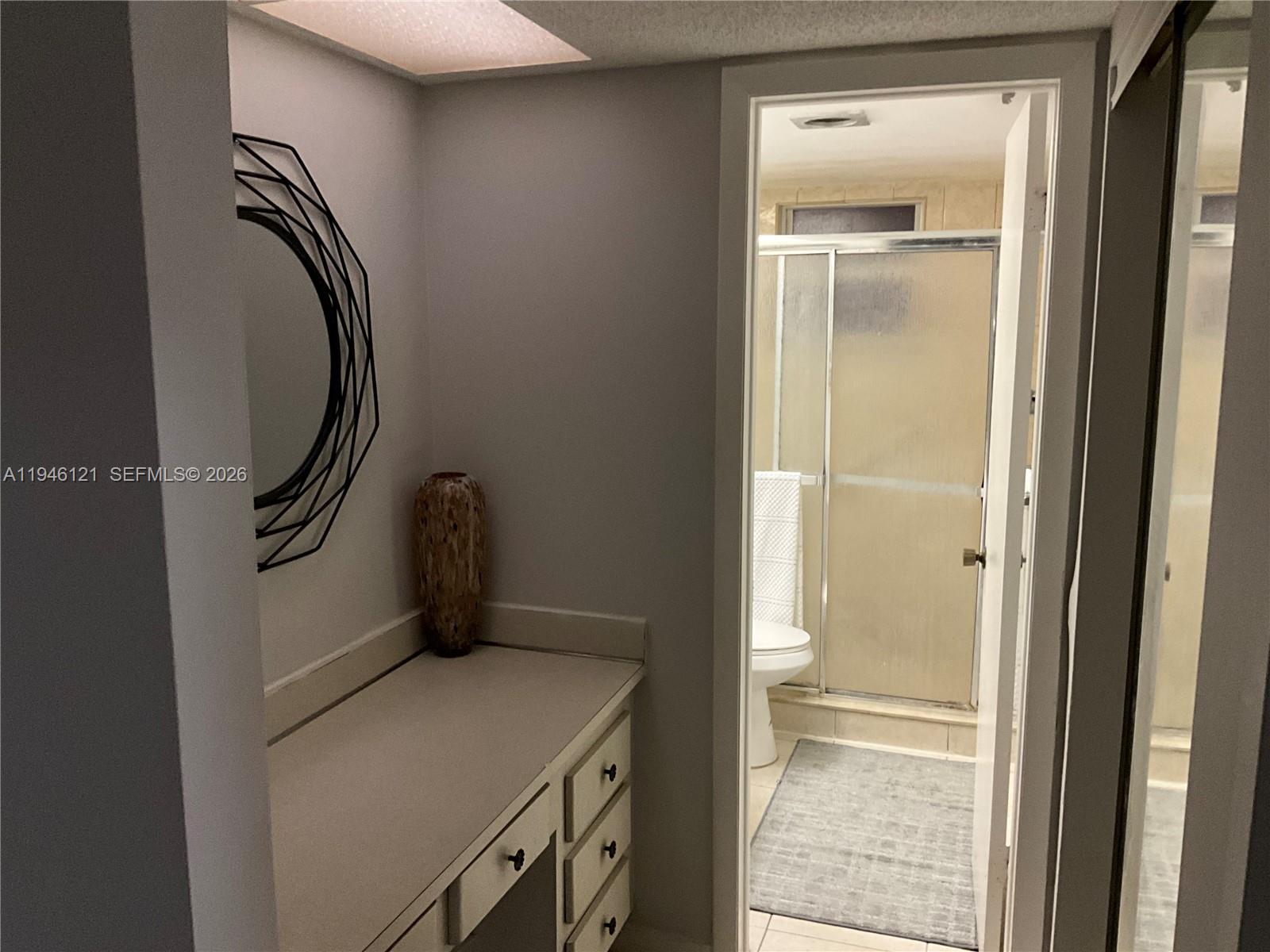 101 Berkley Road, Unit 205 Hollywood, FL 33024 - Photo 8 of 13 a bathroom with a granite countertop toilet and a sink