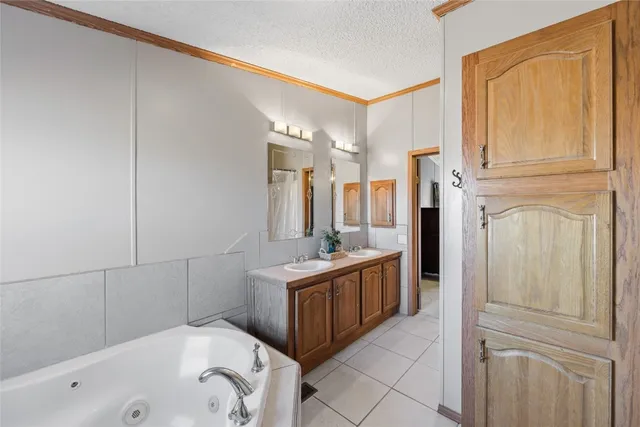 a bathroom with a tub sink and mirror