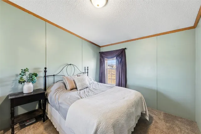 a bedroom with a large bed and a potted plant