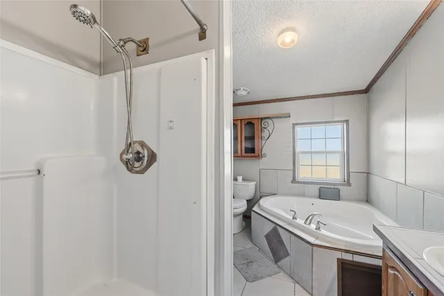 a bathroom with a granite countertop bathtub sink vanity and toilet