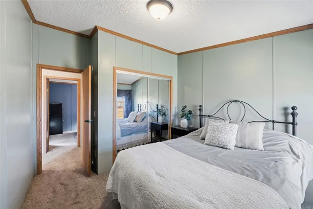 a bedroom with a bed and a mirror