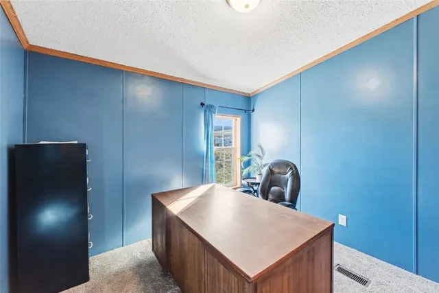 a workspace room with furniture and a potted plant