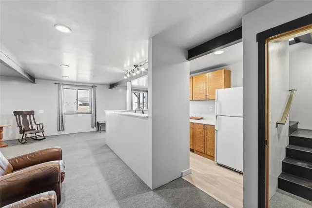 a kitchen with stainless steel appliances a sink a stove and a wooden floors