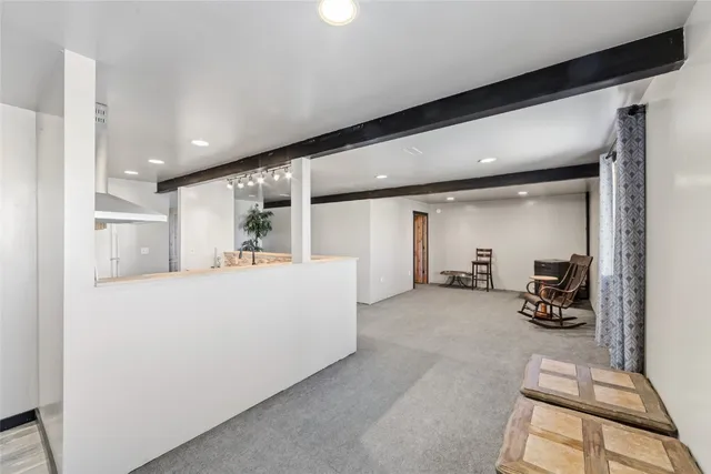 a view of a kitchen with a sink and a refrigerator