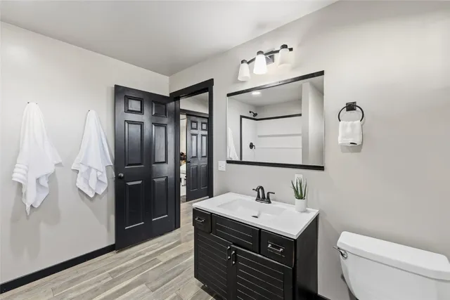 a view of a hallway with wooden floor and closet