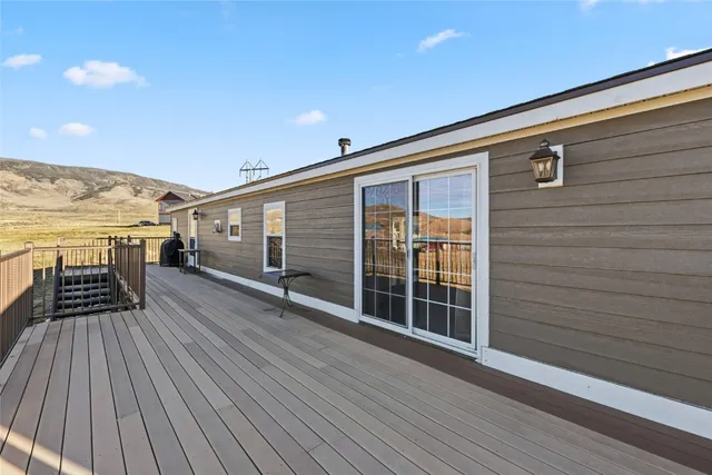 a view of deck with a table and chairs