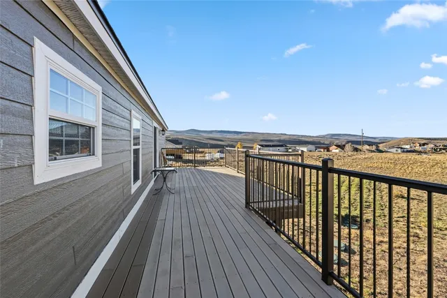a view of deck with a table and chairs