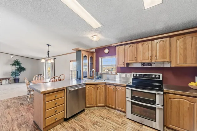 a kitchen with stainless steel appliances granite countertop a stove and cabinets
