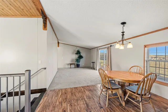 a dining room with furniture and wooden floor