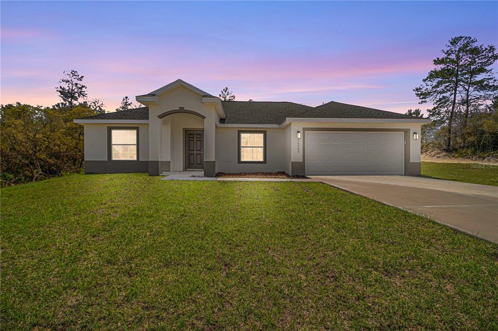 5608 153rd Street Road Ocala, FL 34473 - Photo 1 of 1 a front view of a house with yard and green space