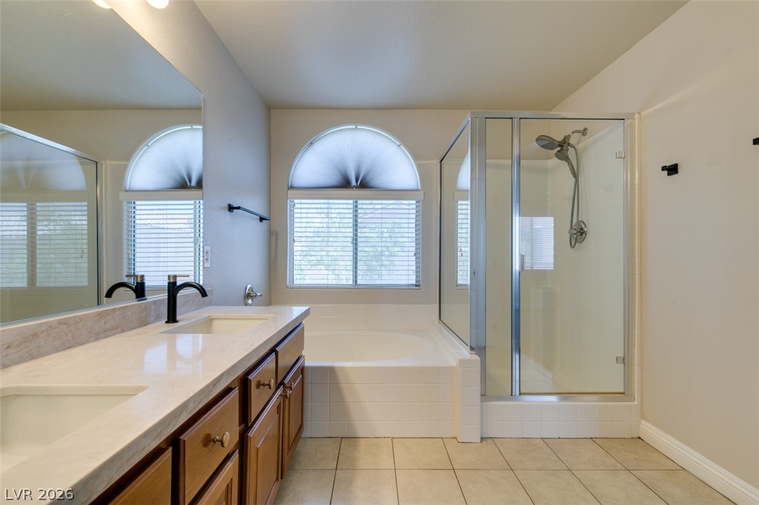 8909 Houston Ridge Avenue Las Vegas, NV 89178 - Photo 38 of 45 Dual vanity with a shower and soaking tub offer an owner's retreat.