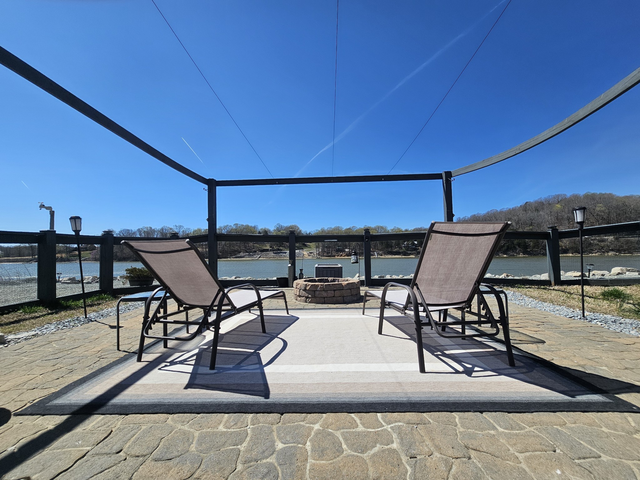 a view of a patio with table and chairs under an umbrella