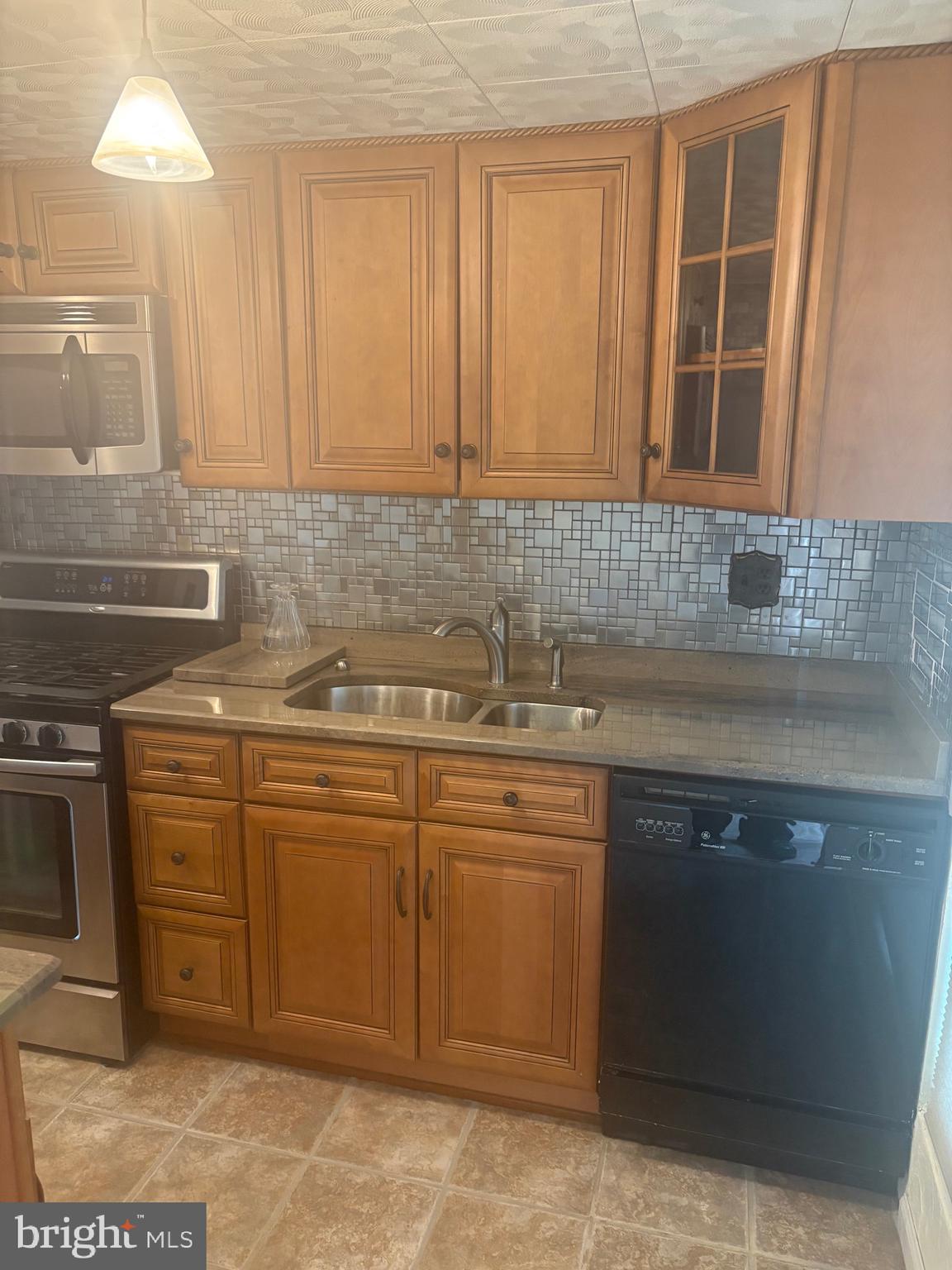 11829 Academy Road, Unit 29B Philadelphia, PA 19154 - Photo 11 of 33 a kitchen with a sink and cabinets