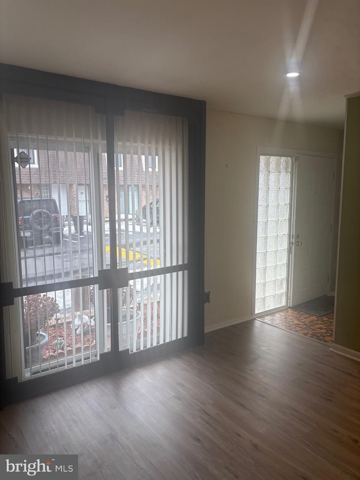 11829 Academy Road, Unit 29B Philadelphia, PA 19154 - Photo 32 of 33 a view of an empty room with wooden floor and a window
