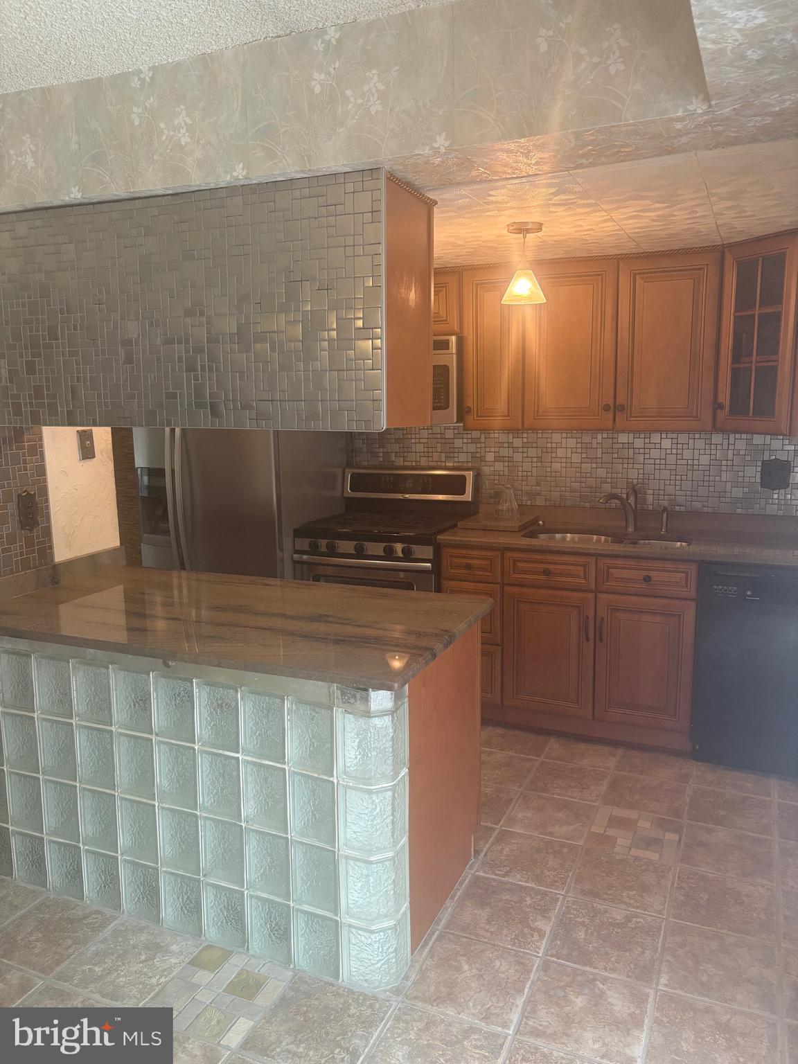 11829 Academy Road, Unit 29B Philadelphia, PA 19154 - Photo 6 of 33 a kitchen with a sink a stove and cabinets