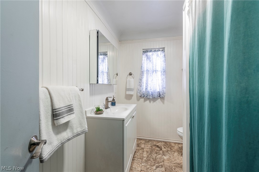 21779 Eaton Road Cleveland, OH 44126 - Photo 29 of 46 Bathroom featuring tile floors, crown molding, toilet, and large vanity