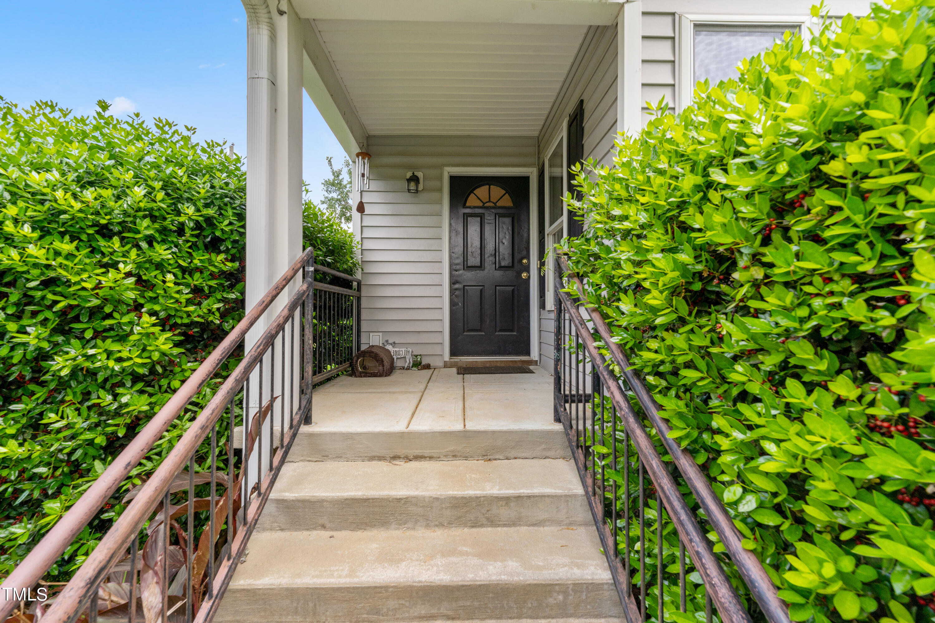 1005 Chaney Road Raleigh, NC 27606 - Photo 2 of 18 a view of a pathway of a house with flower plants