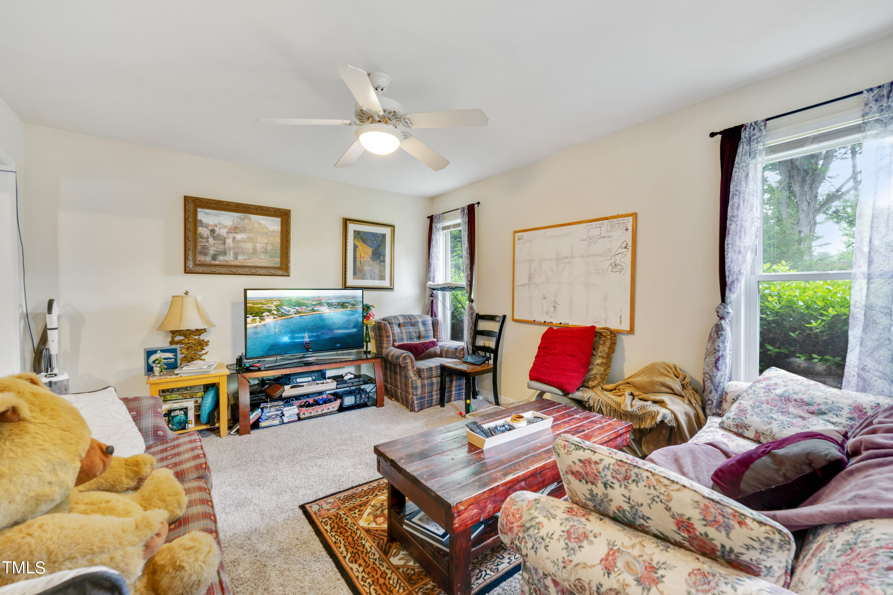 1005 Chaney Road Raleigh, NC 27606 - Photo 3 of 18 a living room with furniture a rug and a window