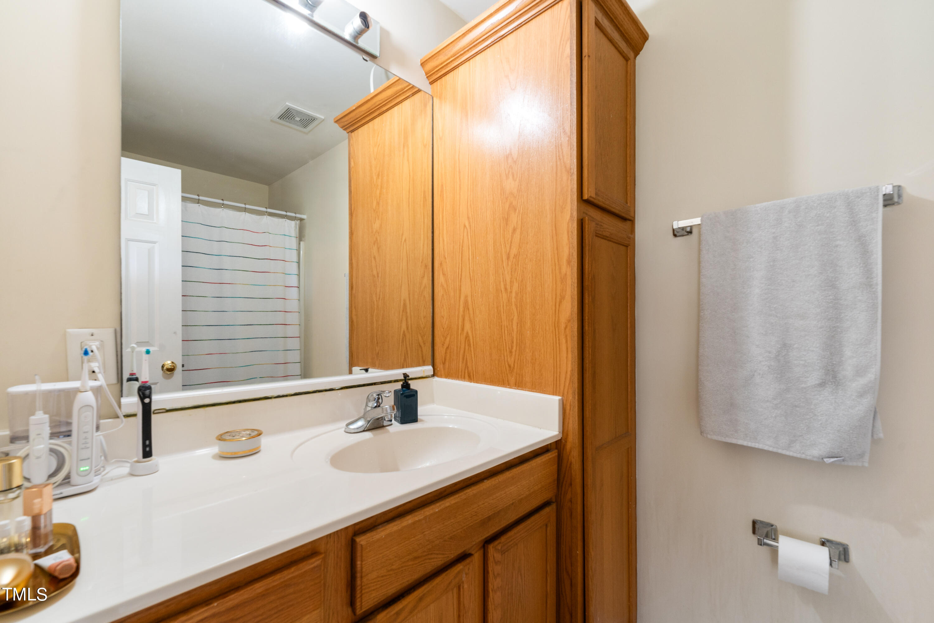1005 Chaney Road Raleigh, NC 27606 - Photo 9 of 18 a bathroom with a sink and a mirror