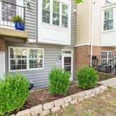 a view of a house with many windows and plants