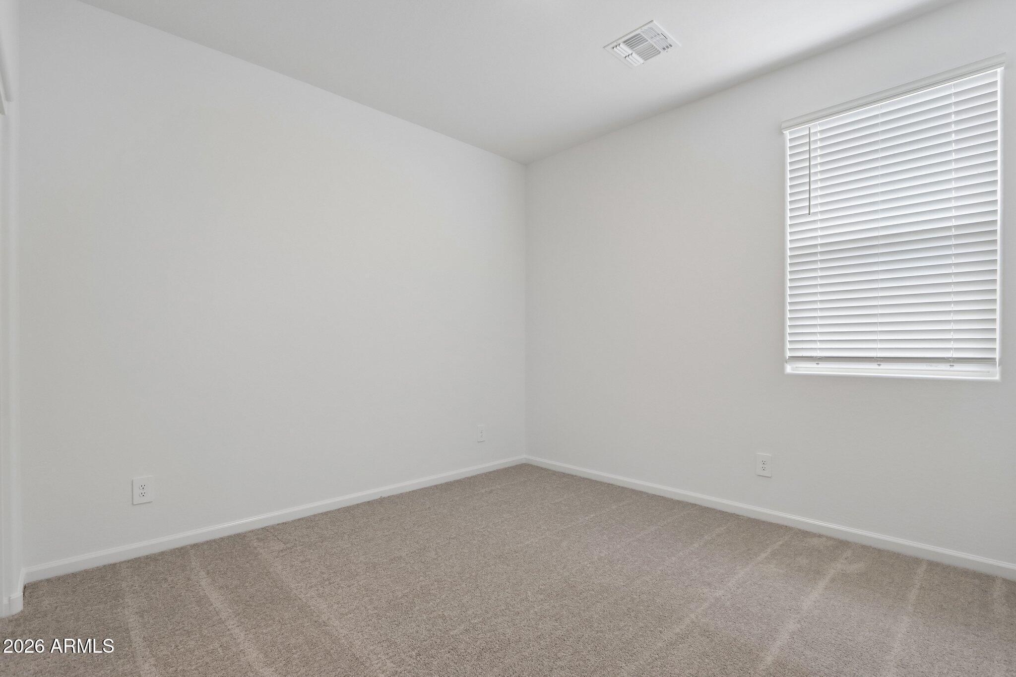 9544 West Gaby Road Tolleson, AZ 85353 - Photo 29 of 43 an empty room with a window