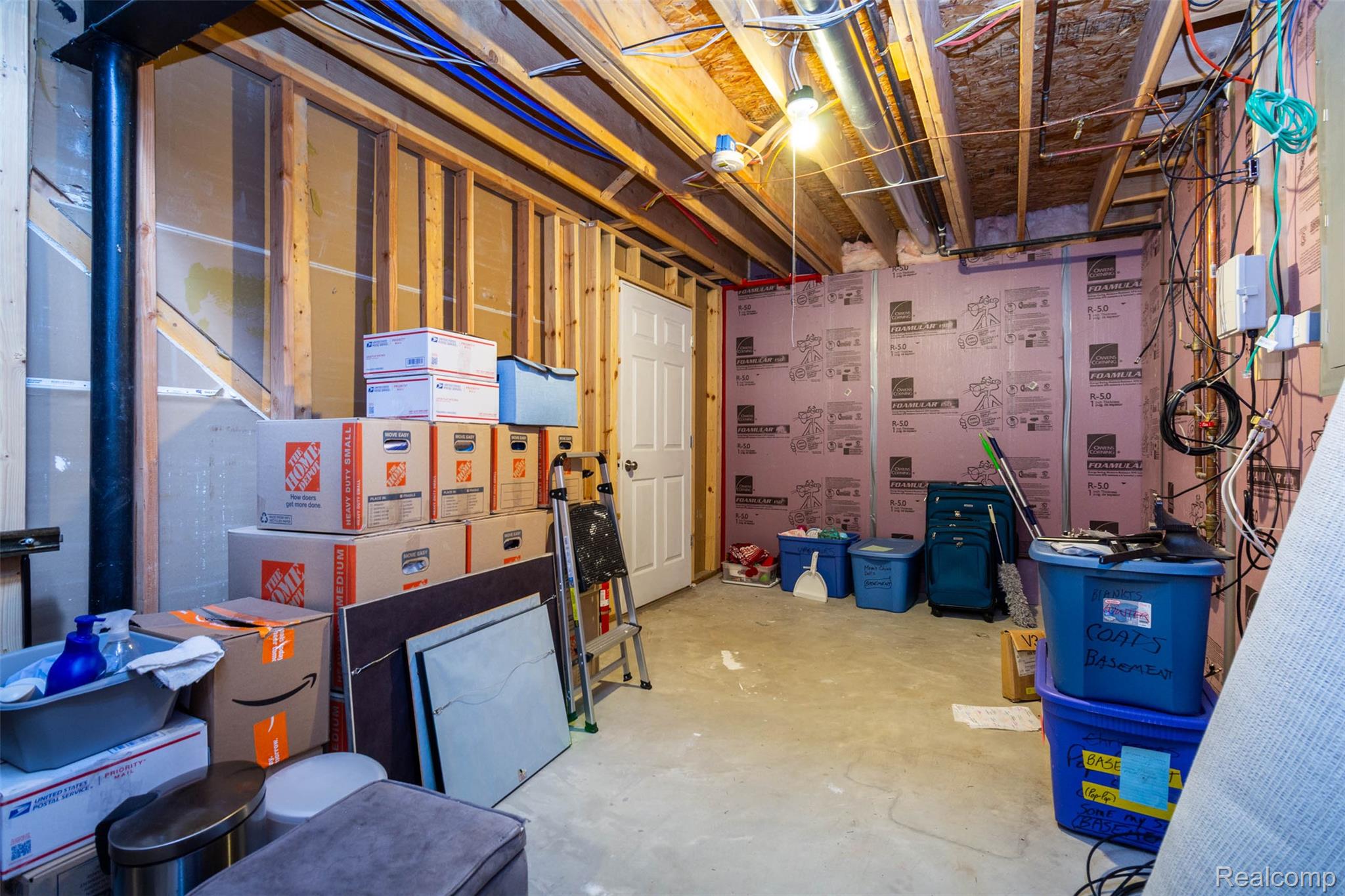 36039 Curtis Road Livonia, MI 48152 - Photo 47 of 61 Unfinished basement featuring exposed wood framing, concrete flooring, pink foam board insulation, and visible electrical wiring