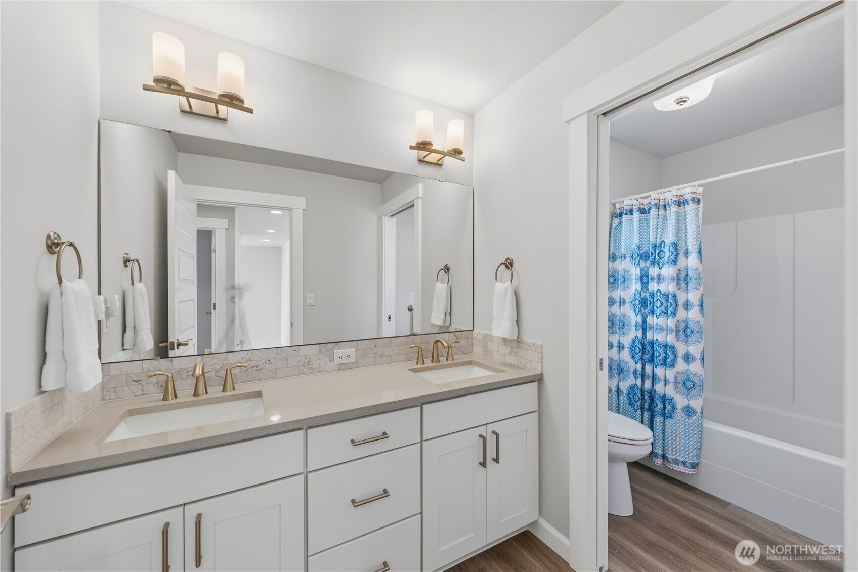 405 Maple Avenue La Conner, WA 98257 - Photo 24 of 40 a bathroom with a granite countertop sink a toilet and a large mirror