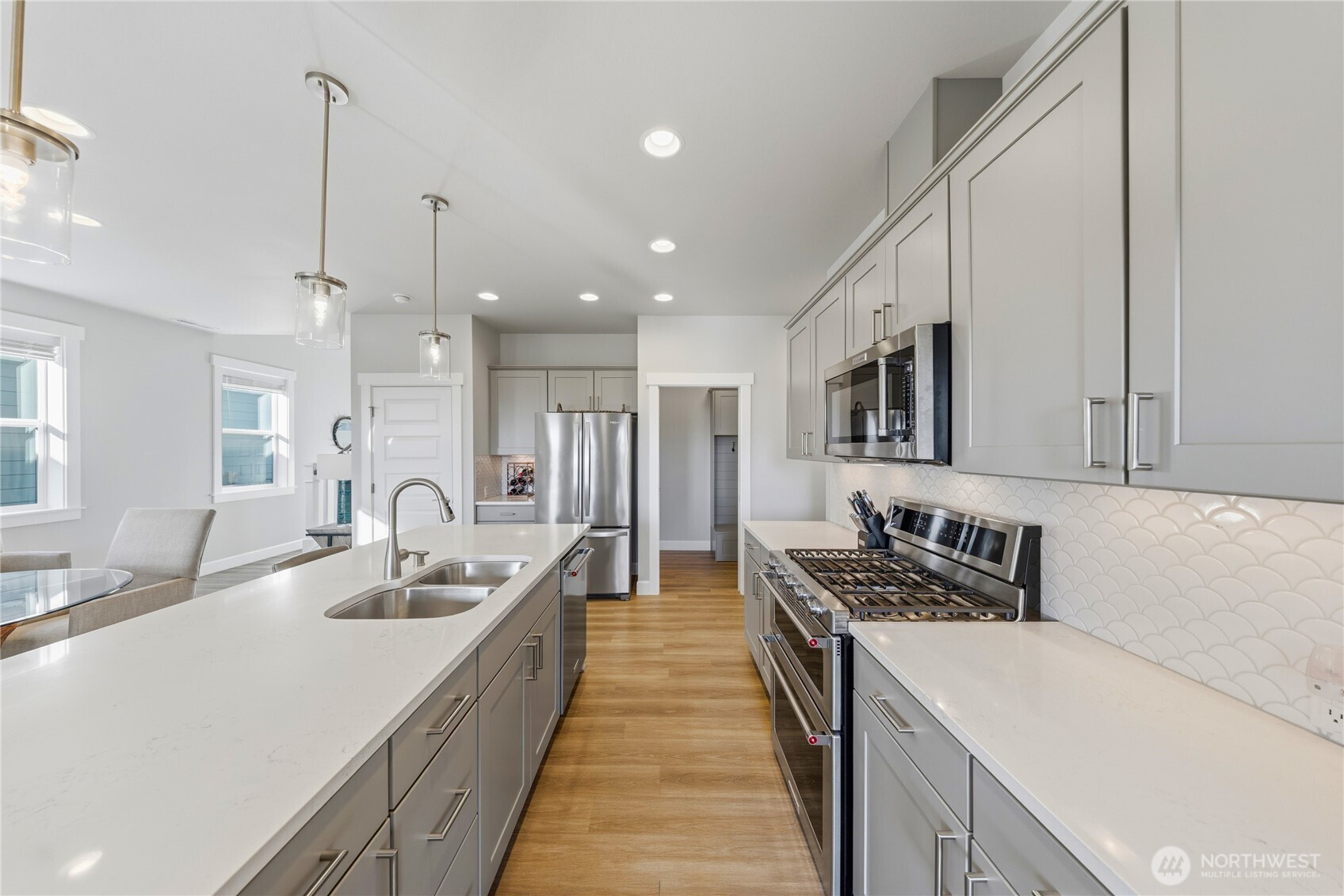 405 Maple Avenue La Conner, WA 98257 - Photo 26 of 40 a kitchen with stainless steel appliances kitchen island granite countertop a sink a stove and cabinets