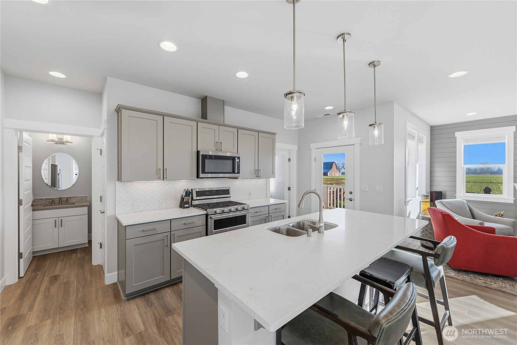 405 Maple Avenue La Conner, WA 98257 - Photo 6 of 40 a kitchen with white cabinets and stainless steel appliances