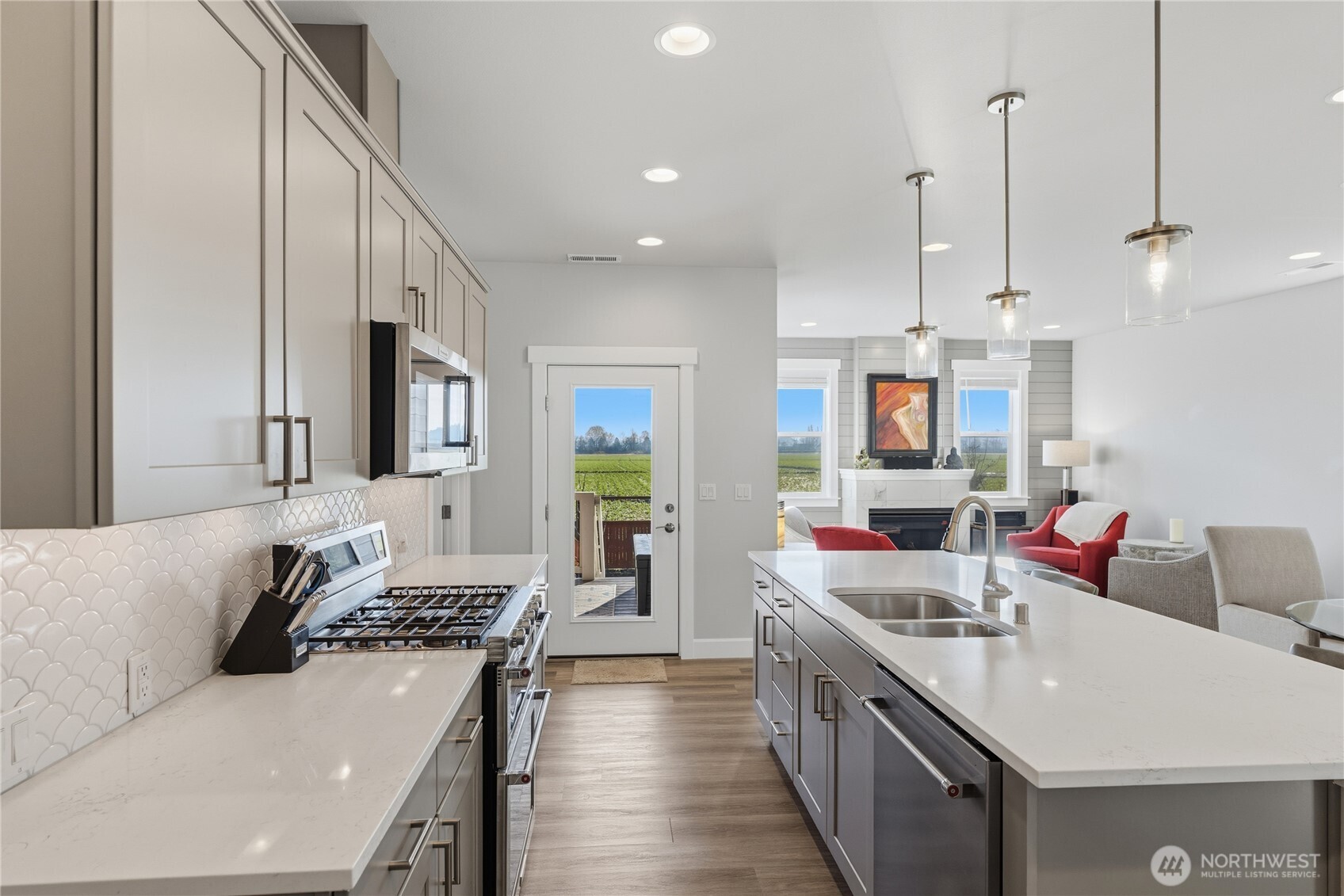 405 Maple Avenue La Conner, WA 98257 - Photo 9 of 40 a kitchen with stainless steel appliances a stove a sink a refrigerator and white cabinets
