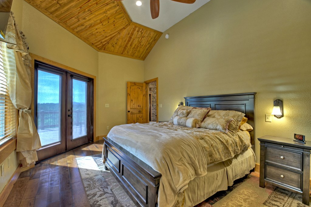 45 Flat Top Trail Murphy, NC 28906 - Photo 21 of 53 a bedroom with a bed and a lamp with mirror on dresser