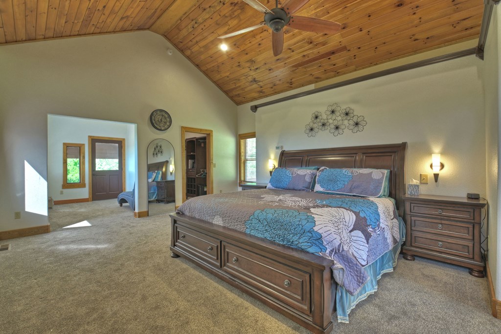 45 Flat Top Trail Murphy, NC 28906 - Photo 29 of 53 a spacious bedroom with a bed and a chandelier
